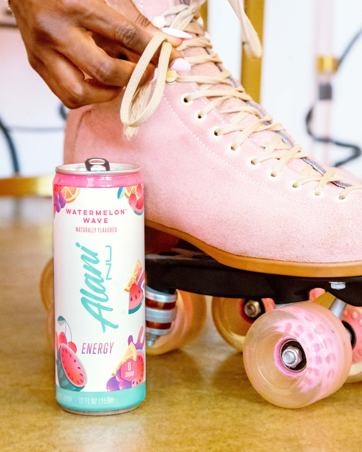 A pink roller skate next to Energy Drink in Watermelon Wave flavor.