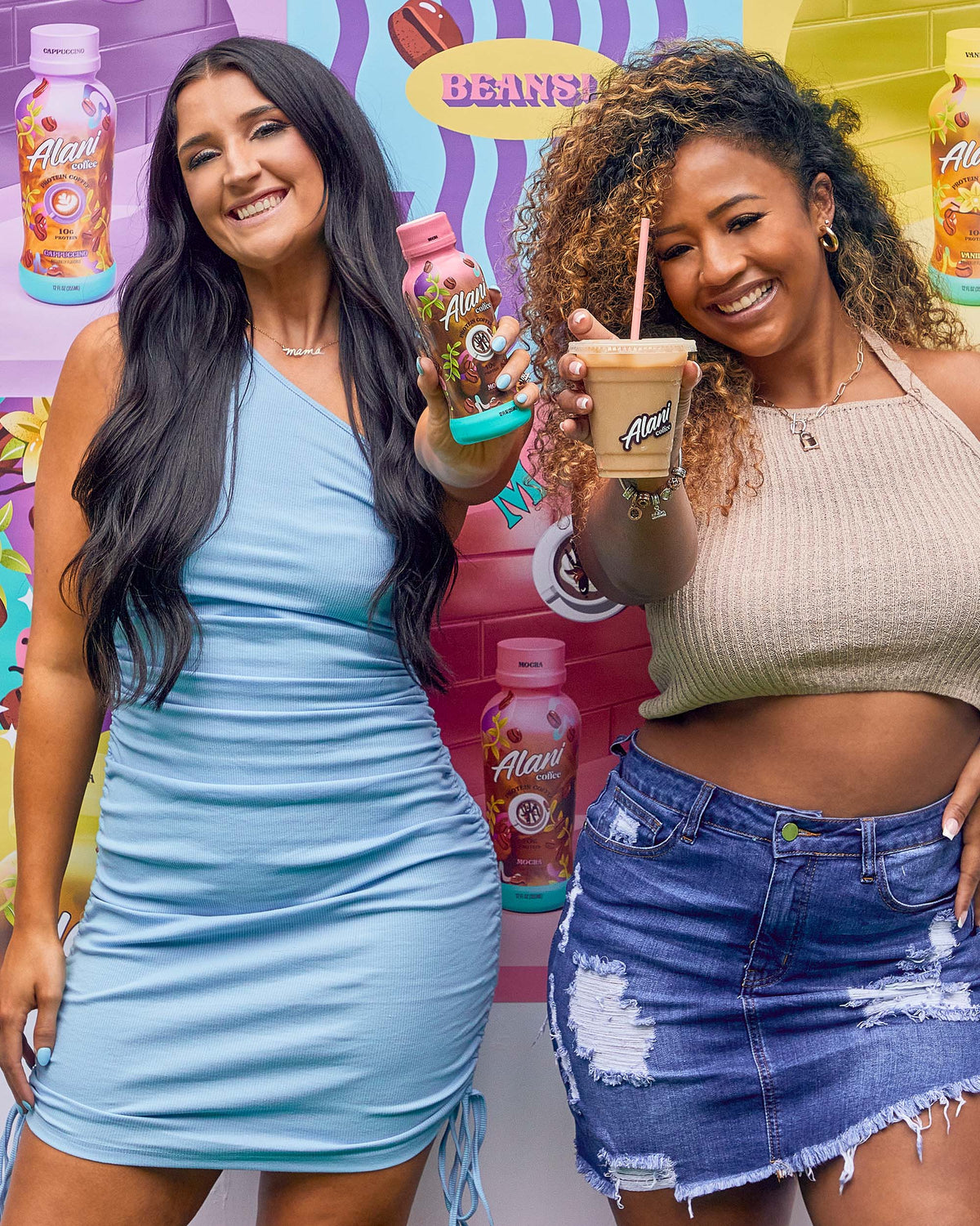 Two women standing next to each other holding coffee in Mocha flavor.